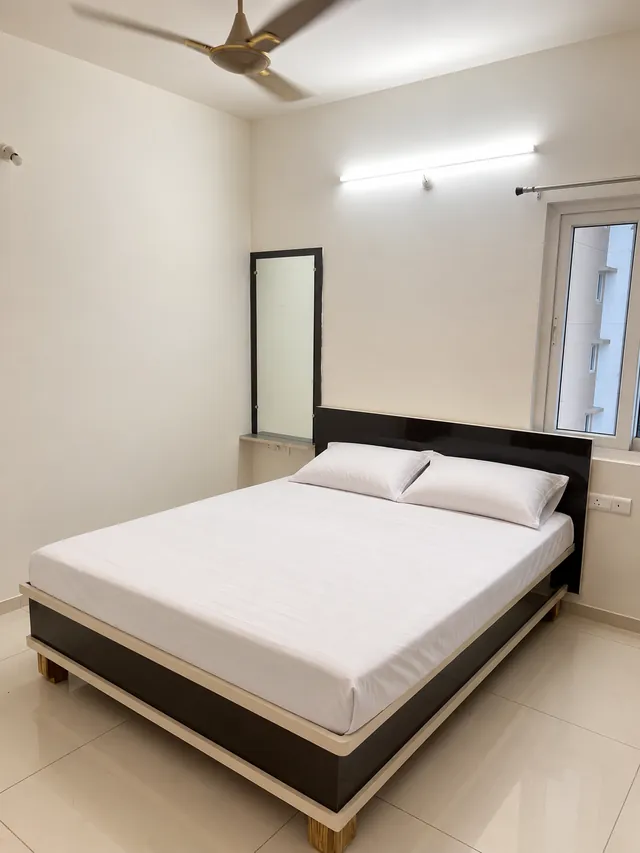 Guest bedroom with black gloss headboard and mirror, completed by Casa Interiors in Hyderabad