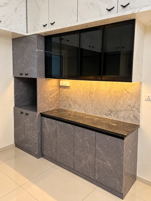 Kitchen tall unit in marble-finish laminate, completed by Casa Interiors in Hyderabad