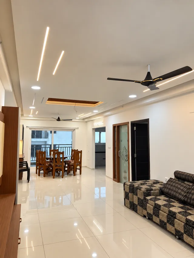 Living and dining hall with linear ceiling lights, completed by Casa Interiors in Hyderabad